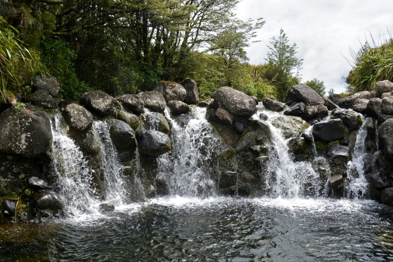 water fall in forest and rocks in stream