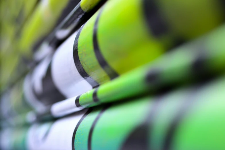 closeup of green tennis balls lined up on a racket