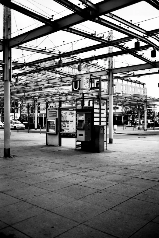 a parking structure with two telephones at one point and two signs on each pole