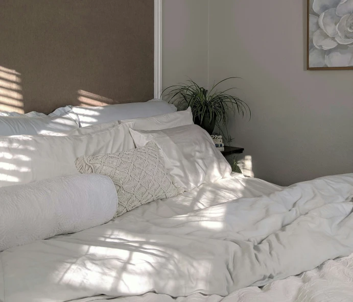 white blankets and pillows on the bed