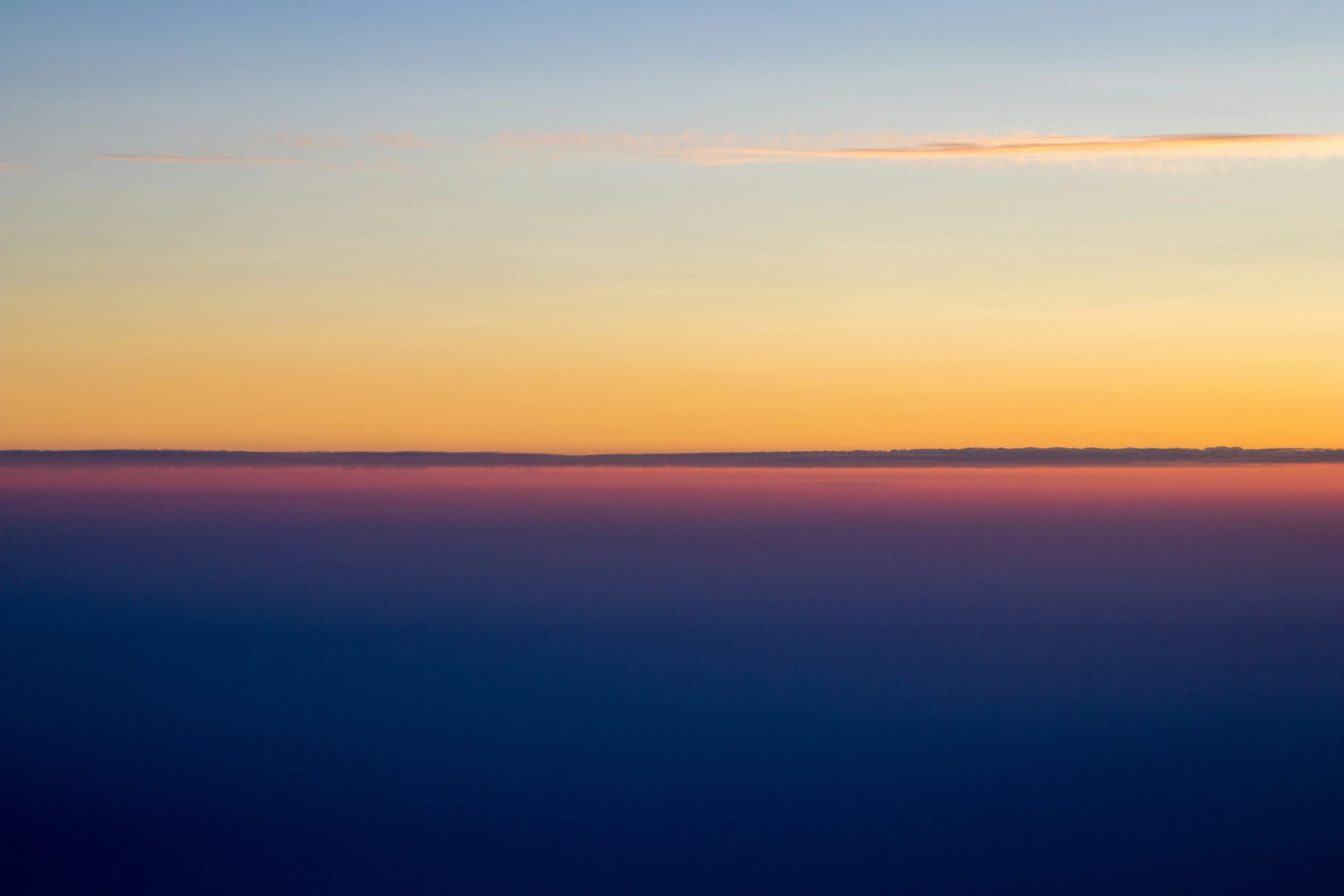 the sun is setting above the horizon of the ocean