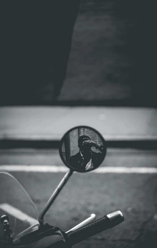 close up po of the side view mirror on a motor bike