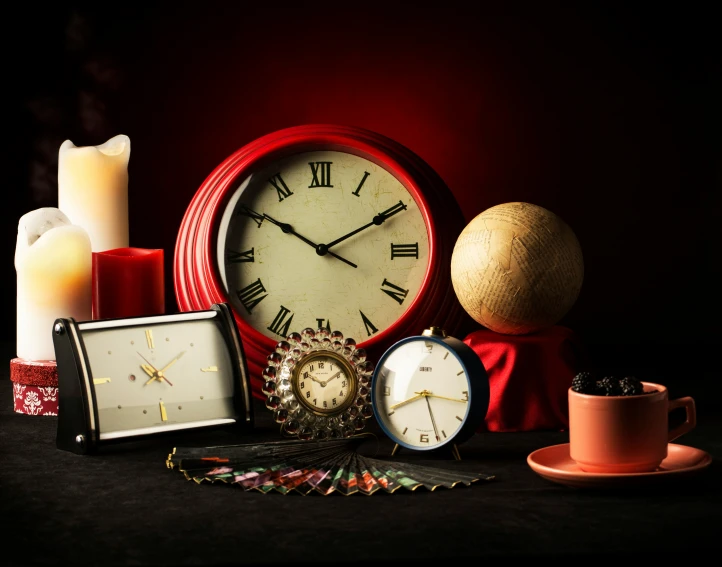 an assortment of small objects including a clock and candles