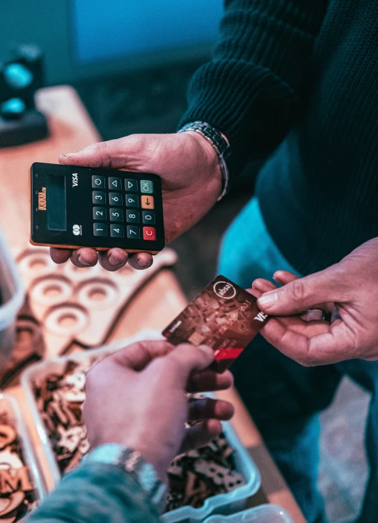 a man and woman are showing off a cell phone