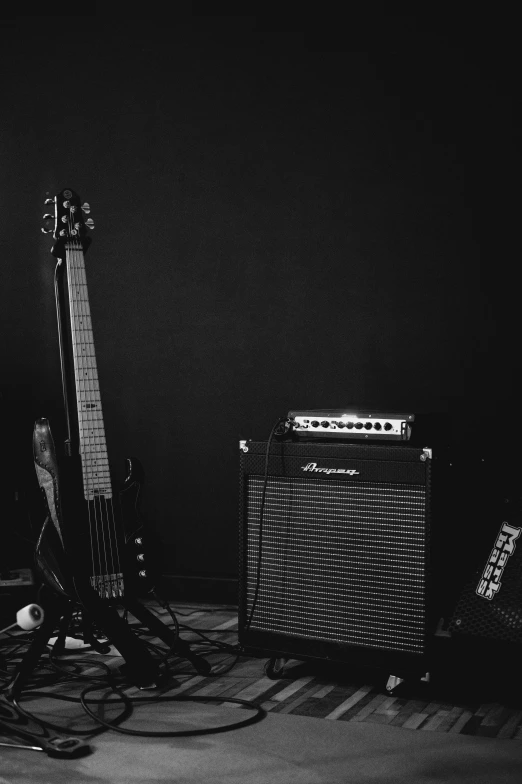 a group of guitars, amps and pedals against a black background