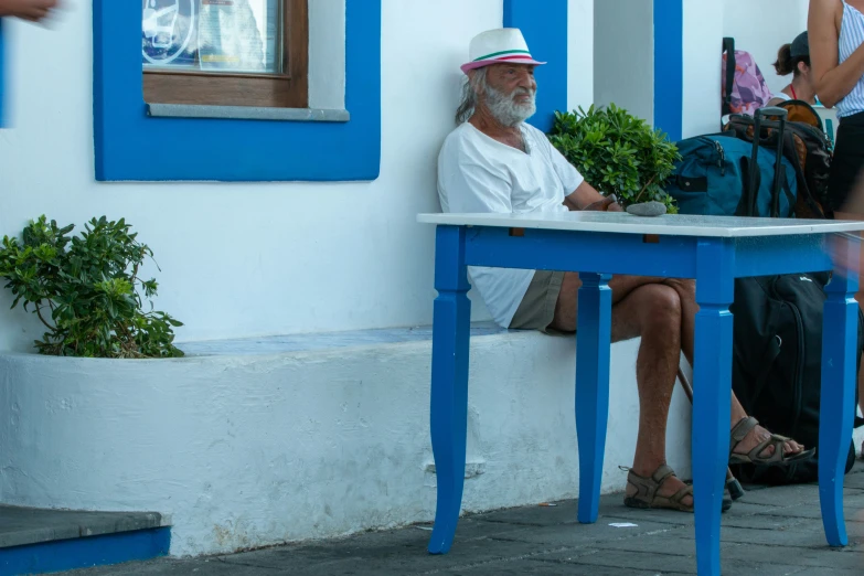 a man sitting at a table talking to a woman