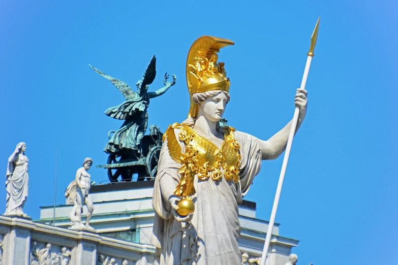 statue with golden headpiece in front of an old building