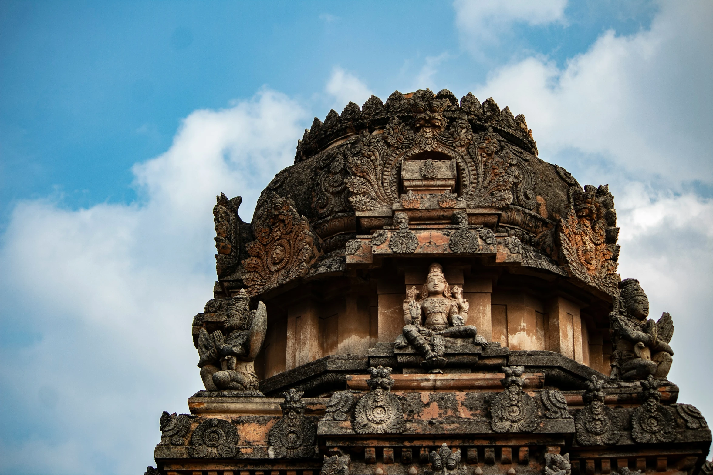 the top of an old building with statues