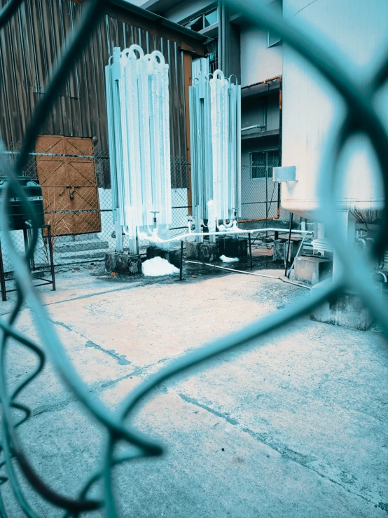 looking through the fence at a building behind a gate