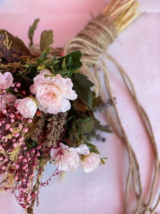 a bunch of pink flowers tied with twine