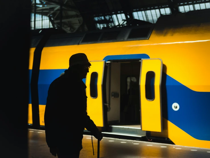 man waiting at a train stop for the train