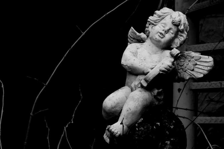 a close up of a statue of a cupid holding an angel