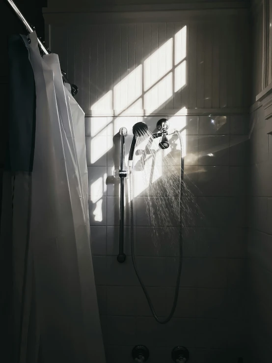 a shower head with a long hose in a shower