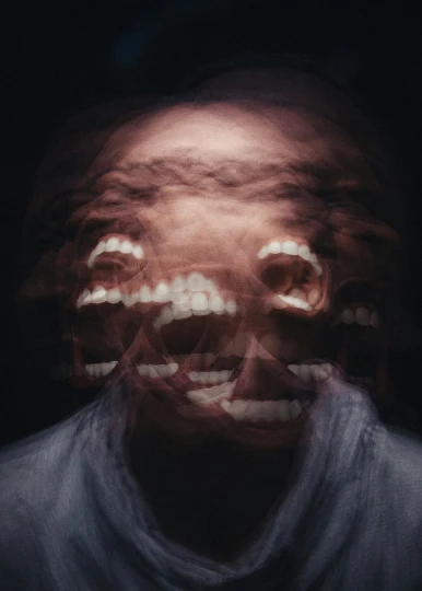 a creepy man with a knife in his hand and some strange lights coming out of his mouth