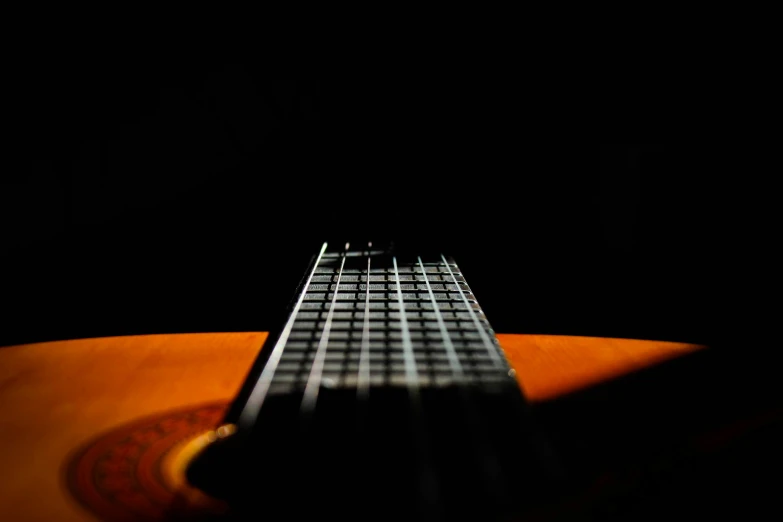 a guitar is on the ground with its fret on it's string