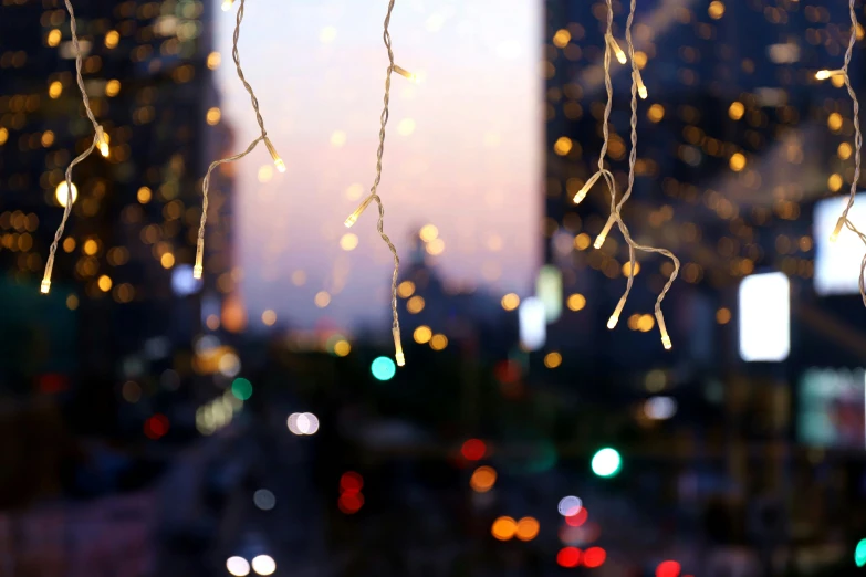 a group of lights on the ceiling and behind them a building in the background