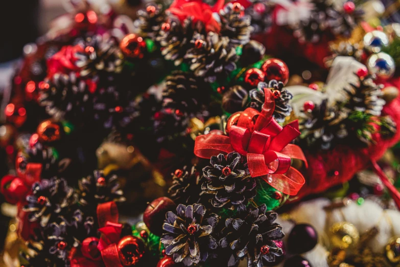 the ornaments of various evergreen trees are red and green