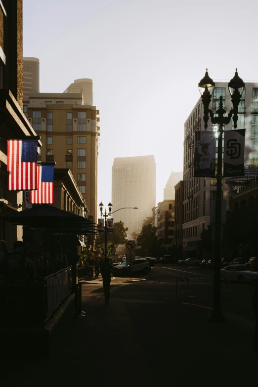 a street in the city with american flags on the building