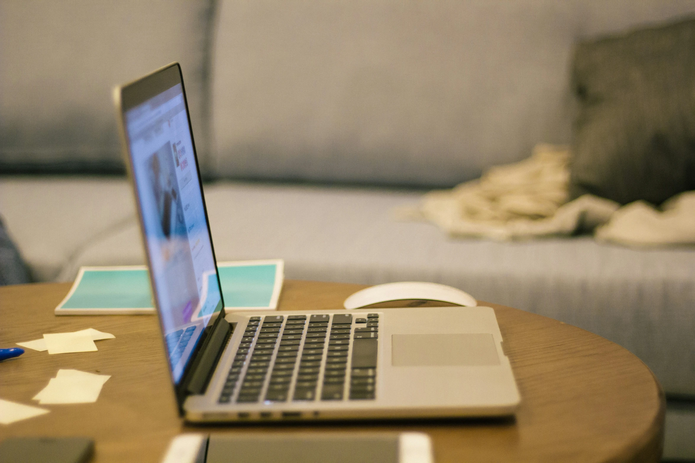 a desk with a laptop and bed on it