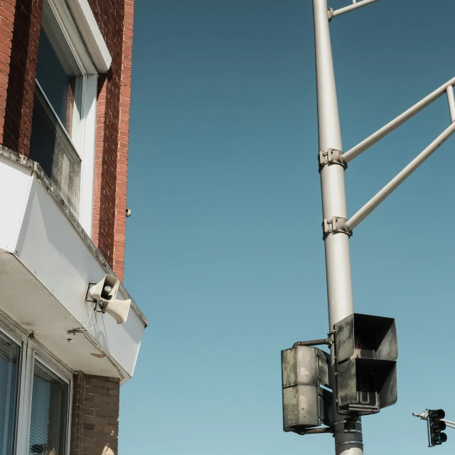 street lights and traffic signal against a blue sky