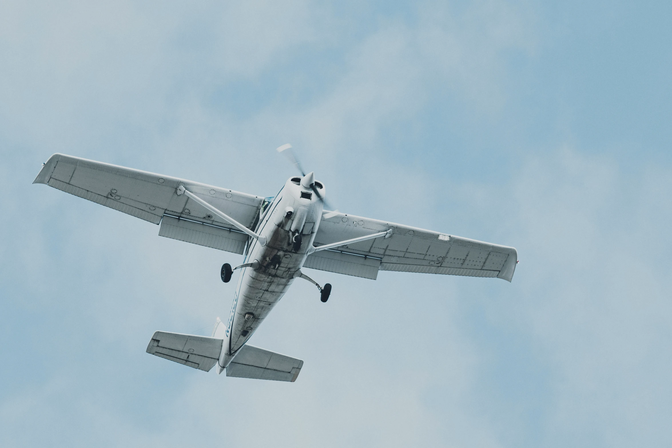 an airplane is flying in the blue sky