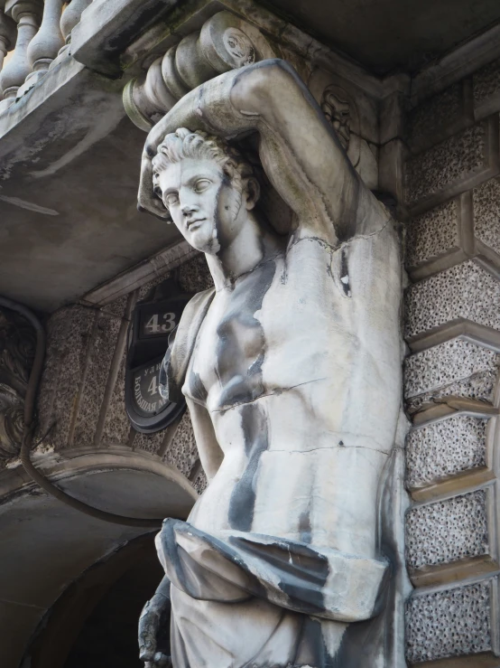 a statue of a male  holding a book