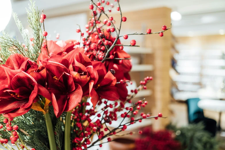 a large vase with flowers is sitting on the table