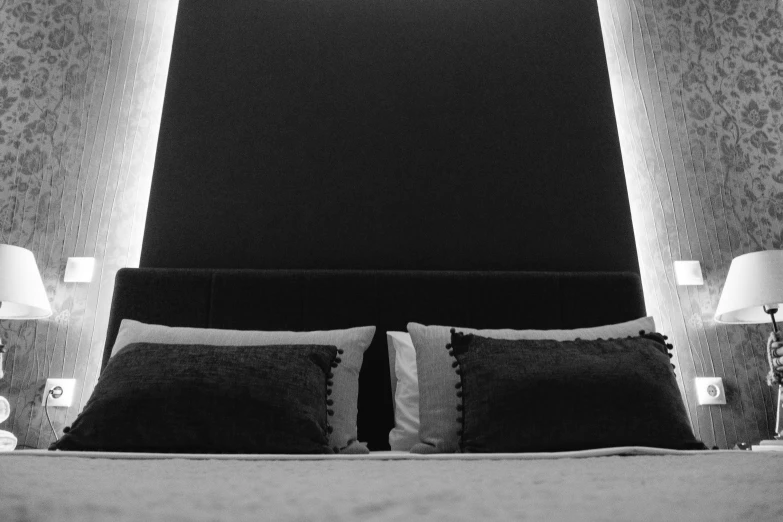 black and white pograph of a well made bed