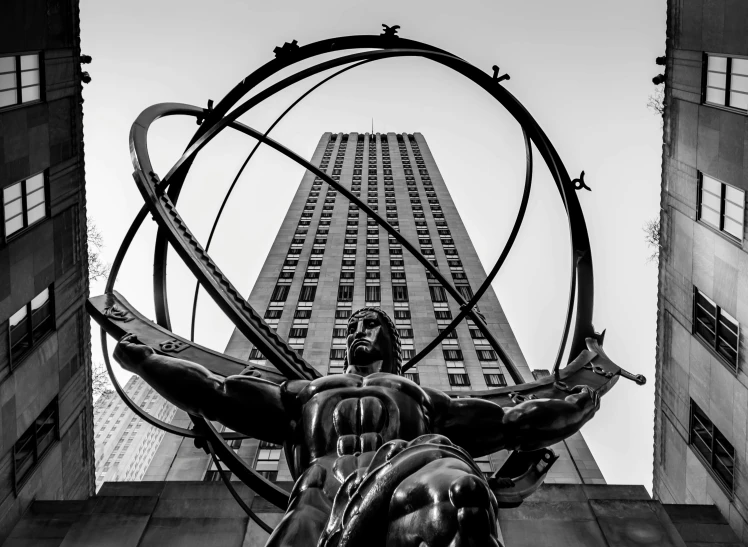 a statue on a pedestal outside an enormous building