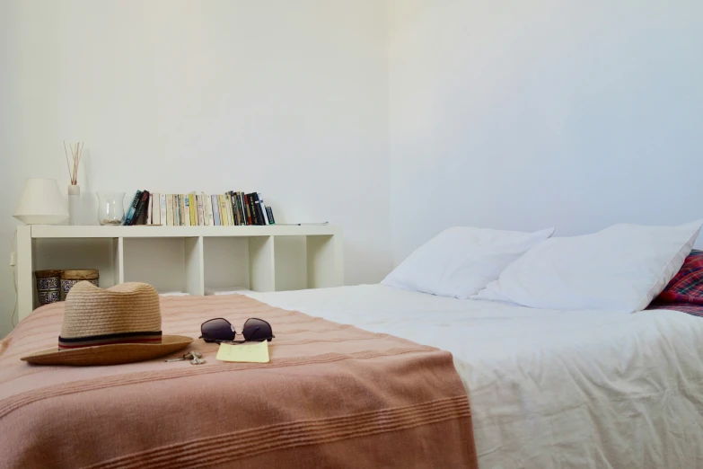 a bed in a room with a white head board and white walls