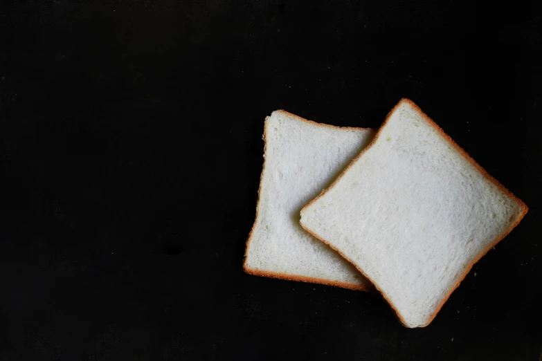 two pieces of toast sit next to each other on a table