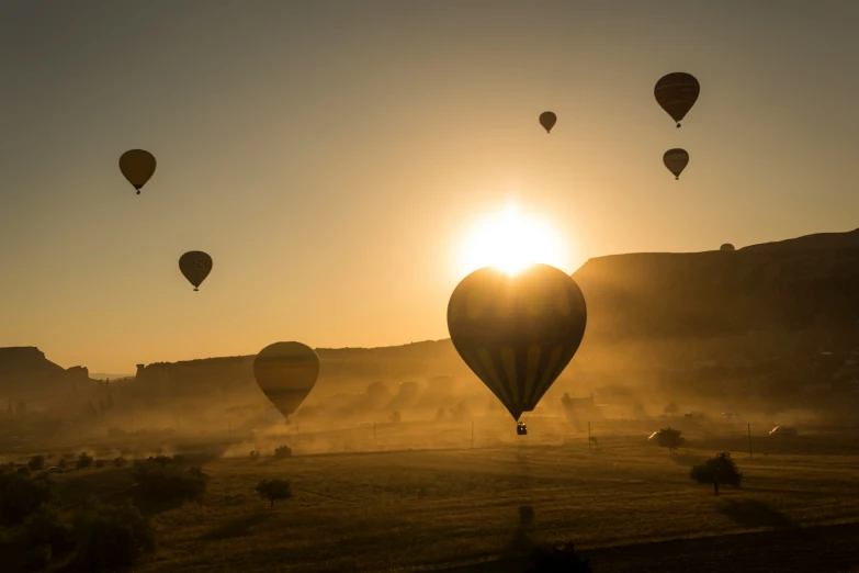 a large number of balloons flying high up in the sky