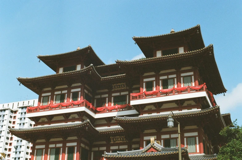 oriental building with red trim and windows on a street