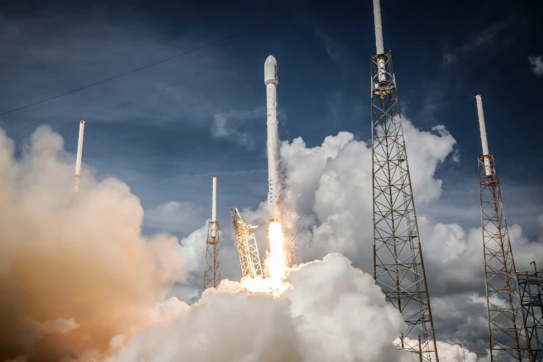 a rocket lifts off into the sky on a sunny day