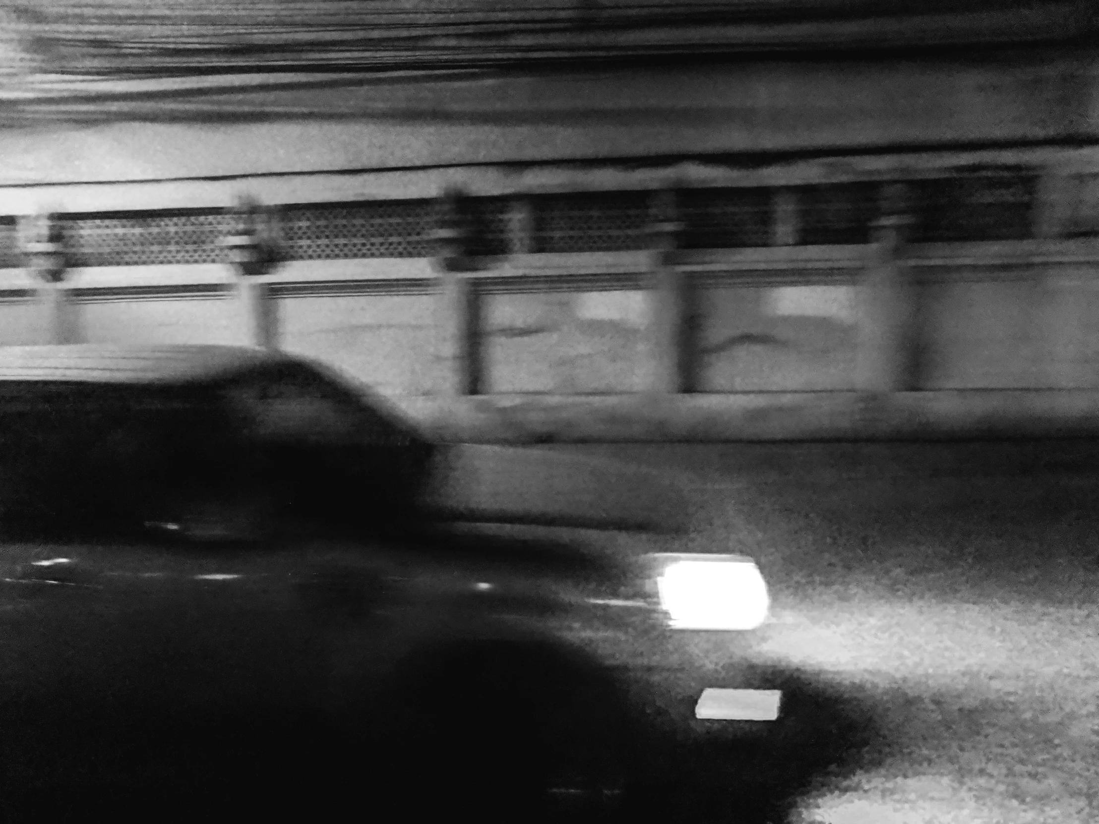 a car driving down the street in front of a building