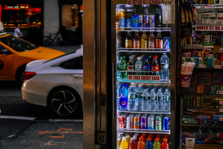 a vending machine displaying drinks on the street