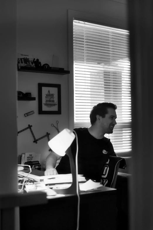 a man sitting at a desk working on a computer