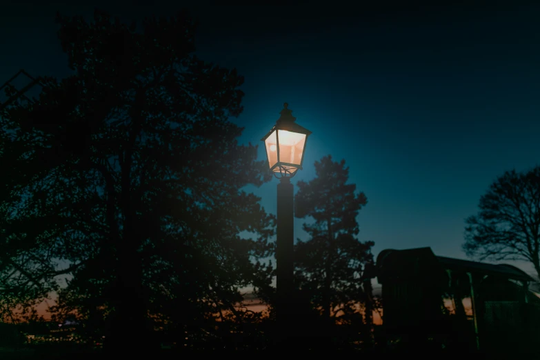 the street lamp is illuminated in the dark at night