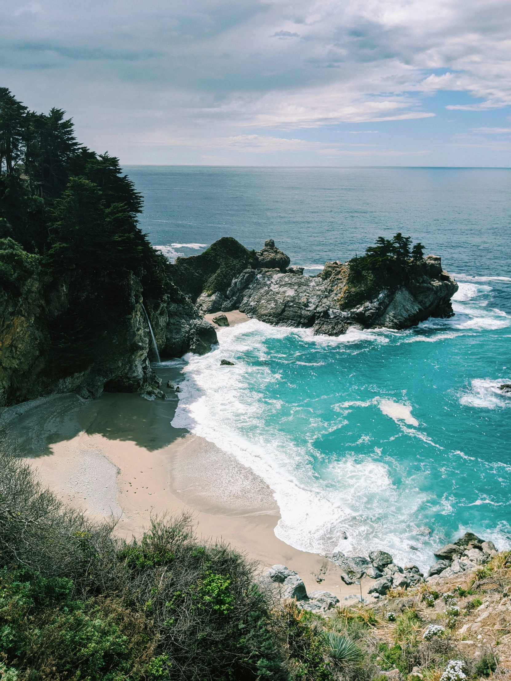 a view of a beautiful beach with some water