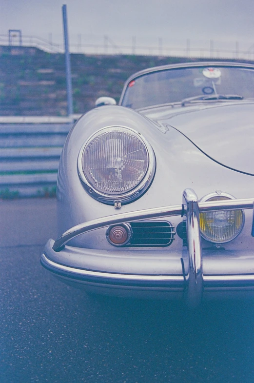 a vintage car parked in a lot on the side of a road