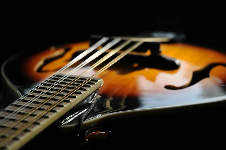 the back end of an electric guitar with the strings on