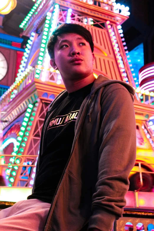 the young man sits next to a clock tower