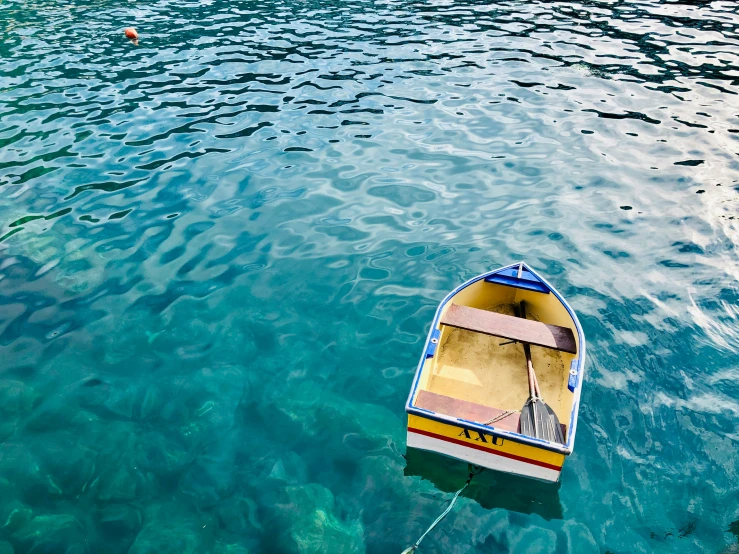 a row boat floating on a lake near mountains