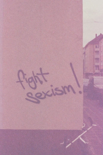 there is graffiti on a sign that reads fight racism