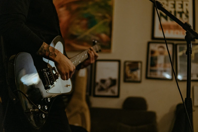 a close - up of man playing a white guitar