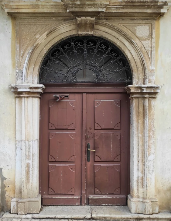 a set of double doors that are outside of an old building