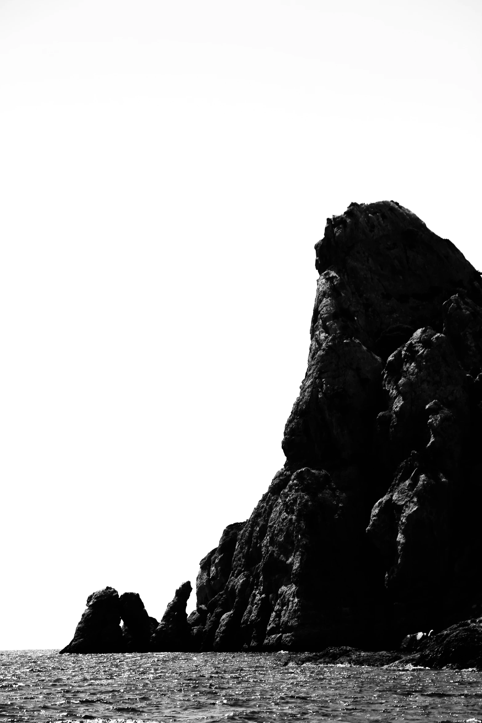 a black and white po of rocks in the ocean