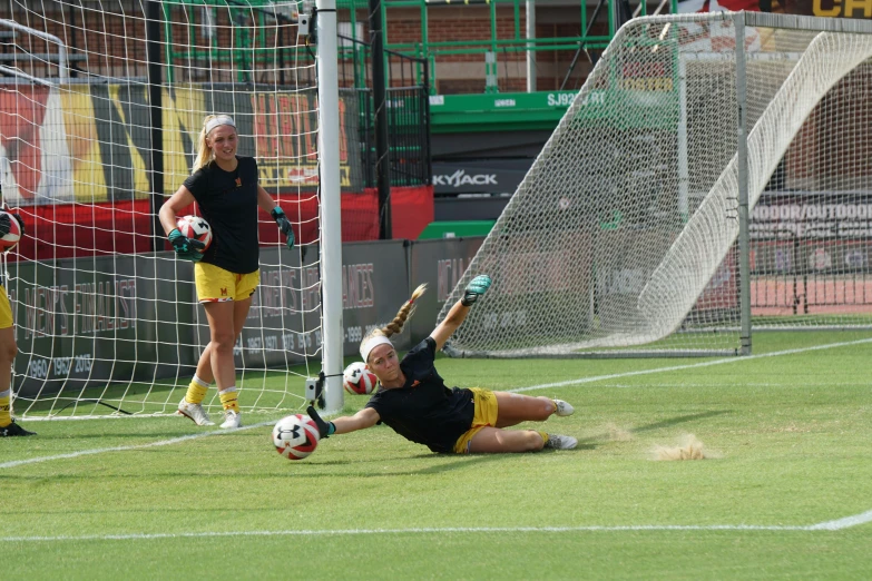 a goalie falling down on the ground to score a goal