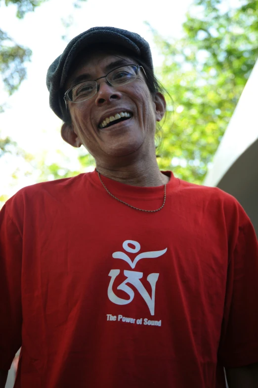 a man standing outside with a red shirt