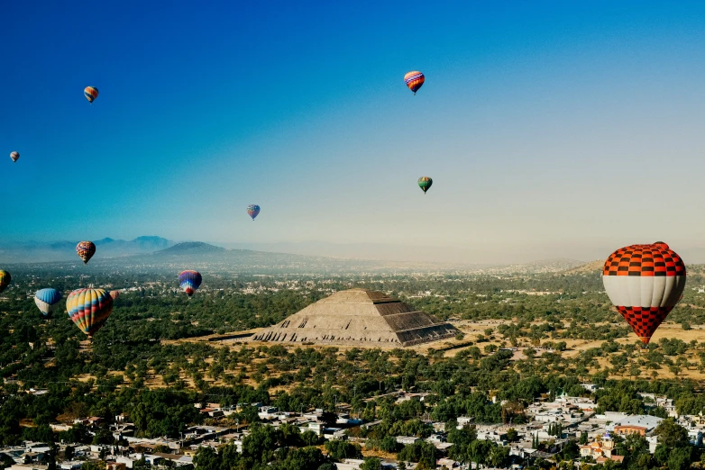 many  air balloons fill the blue sky